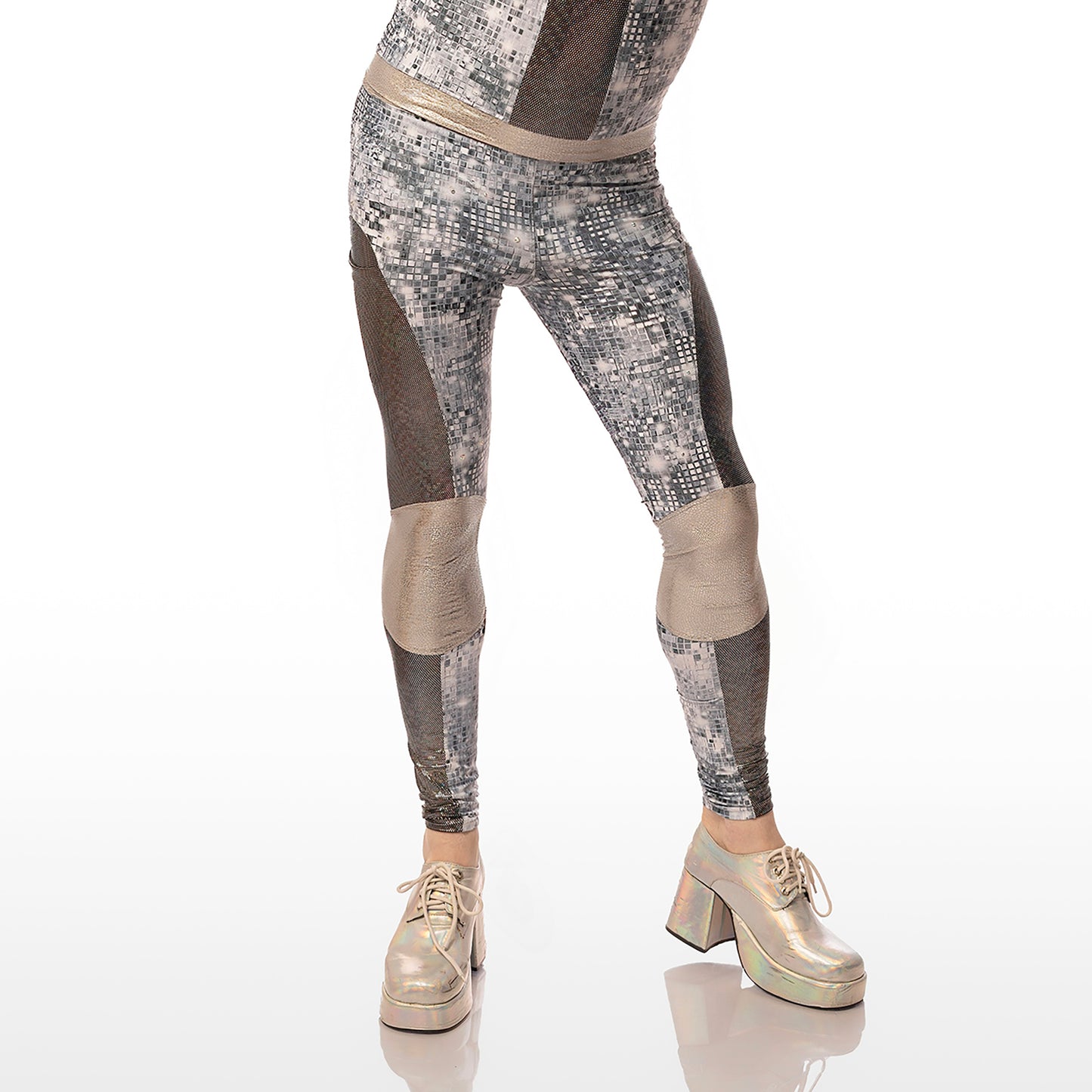 Disco Diva Leggings, a handmade-to-order piece in disco ball and silver foil print spandex. The leggings feature a double layer high waist with light silver knee panels and granite foil curved leg panels. Model Max stands facing the camera. The image is cropped to show just the legs. 
