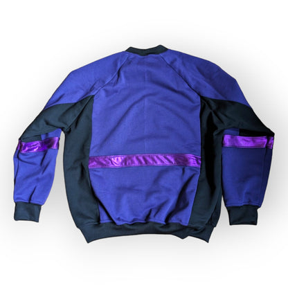 Flat back view of the Purple Snakebite Sweatshirt, a limited edition, off-the-peg piece in purple and black sweatshirt fleece with blue/green/pink snakebite print spandex details. The unisex design features a raglan sleeve, a large front pouch pocket, printed spandex chest panel and pink foiled stripes.