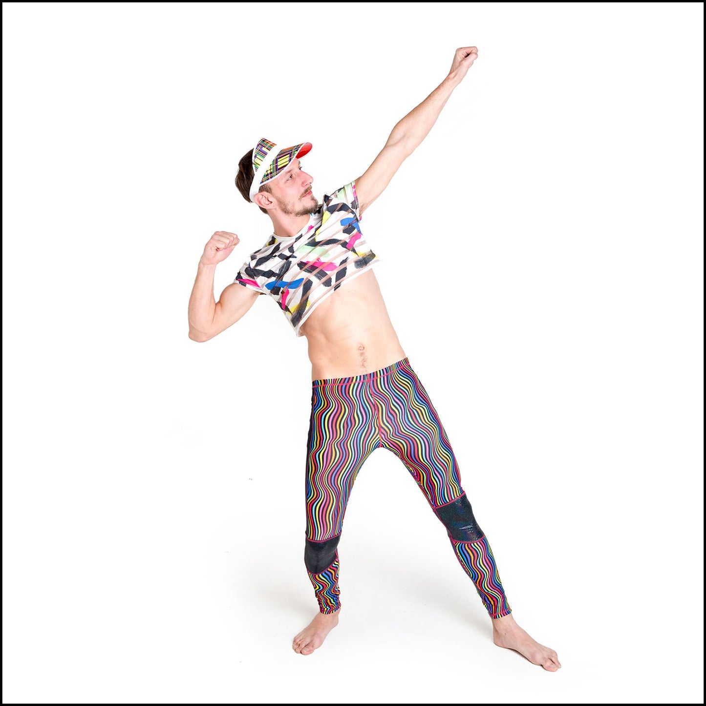 Twisted Leggings, a handmade-to-order piece in rainbow groovy stripe printed spandex. These funky leggings are both stylish and sustainable. The unisex design features a high elasticated waistband and black hologram knee and side panels.