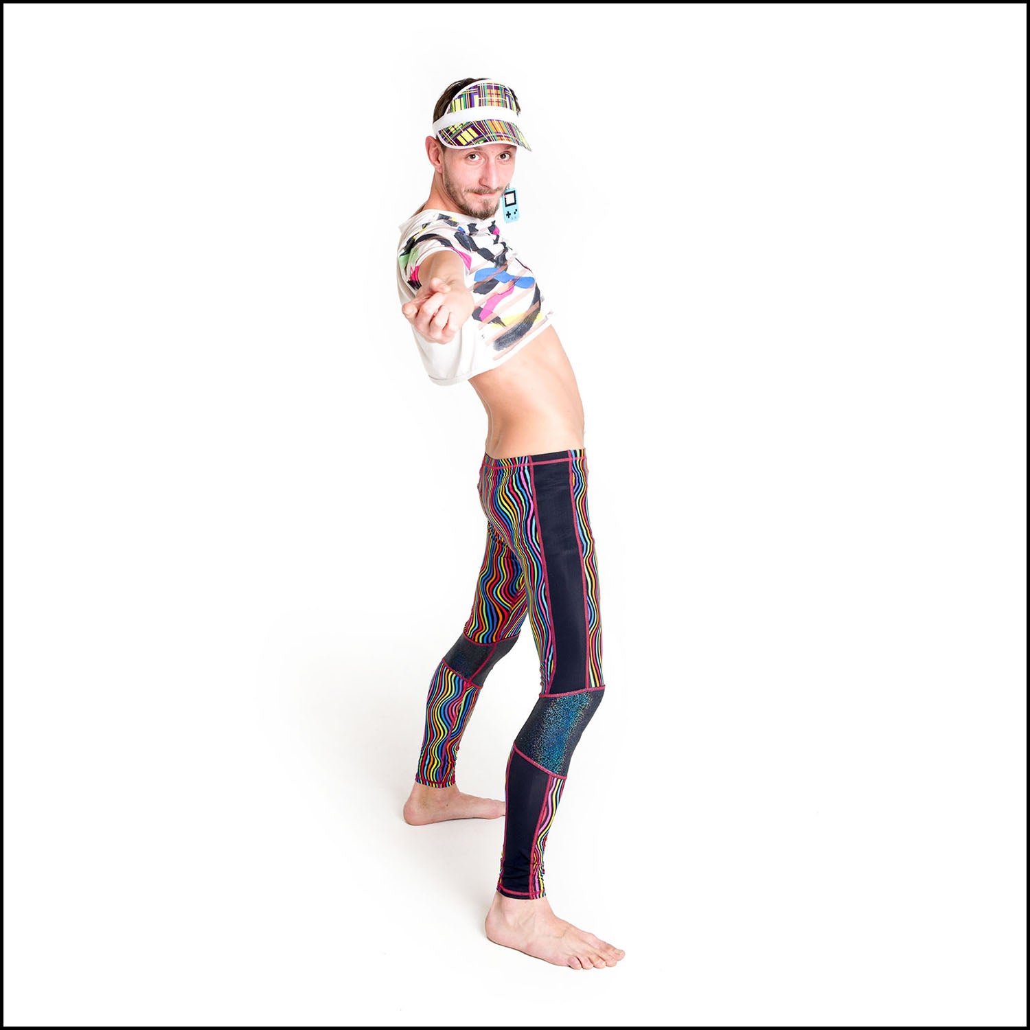 Twisted Leggings, a handmade-to-order piece in rainbow groovy stripe printed spandex. These funky leggings are both stylish and sustainable. The unisex design features a high elasticated waistband and black hologram knee and side panels.