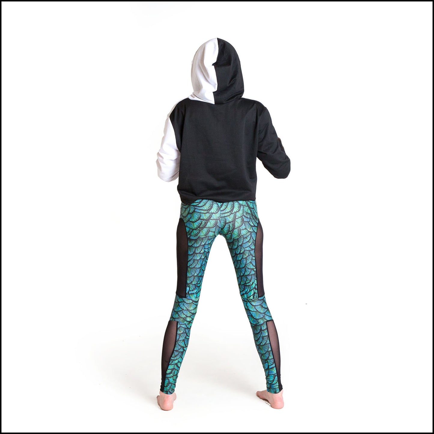 Draco Leggings, a handmade-to-order piece in aqua dragon scale printed spandex. These super cool leggings are both stylish and sustainable. The unisex design features a high double waistband, knee panels and black mesh side panels.