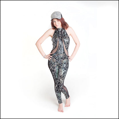 Tangle Lazer Catsuit, a handmade-to-order piece in foil printed tangle lazer spandex. This sexy, low back catsuit is both stylish and sustainable. The figure hugging design features a high halter neck and flattering black mesh inserts that hug your curves in all the right places.